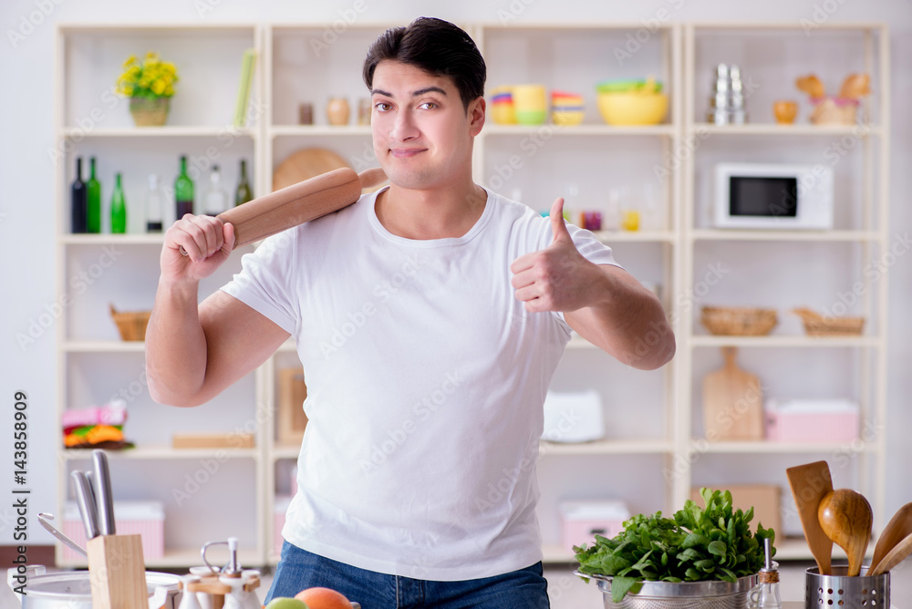 Young male cook working in the kitchen Young male cook working in the kitchen