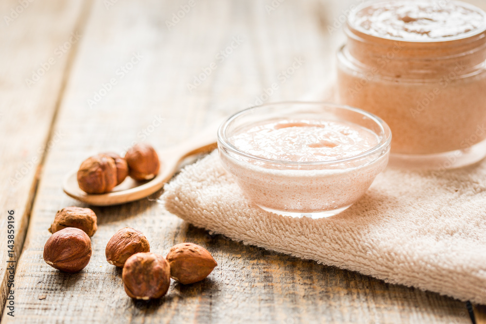 spa concept with hazel-nuts and scrub on wooden background spa concept with hazel-nuts and scrub on wooden background