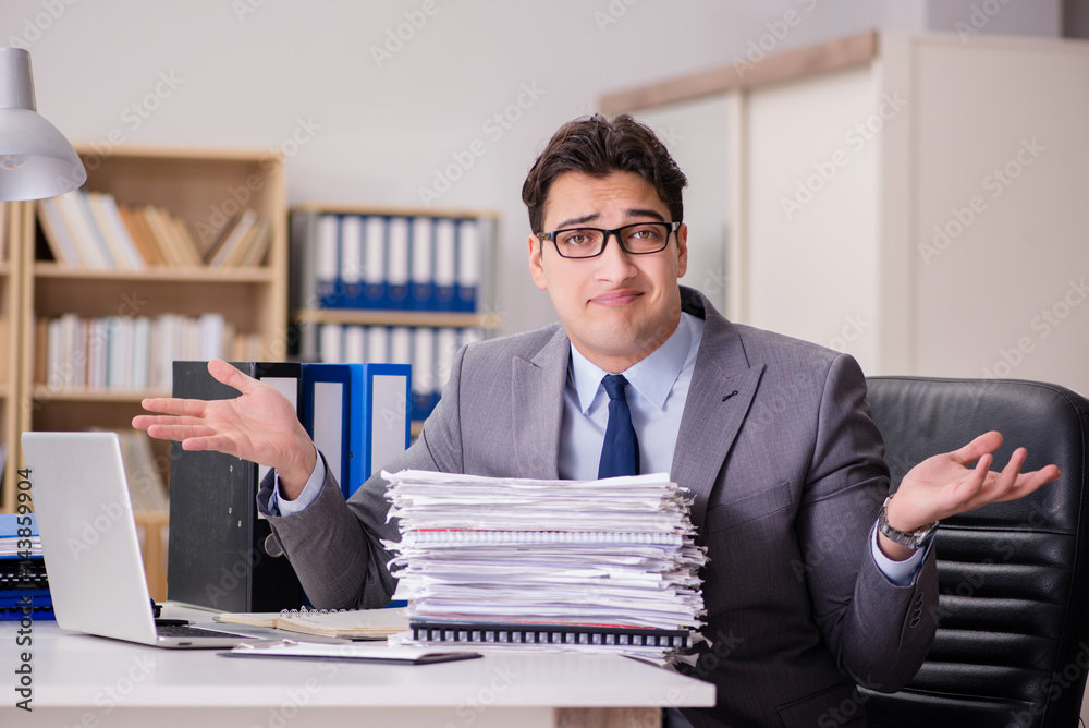 Businessman struggling with stacks of papers Businessman struggling with stacks of papers