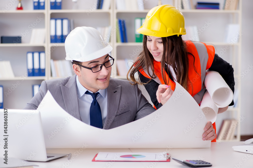 Construction foreman supervisor reviewing drawings Construction foreman supervisor reviewing drawings