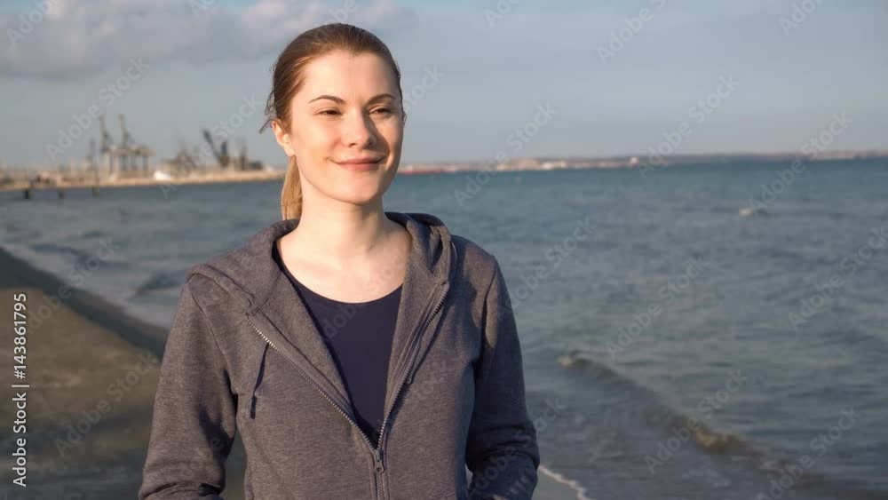 Beautiful attractive young woman walking on beach at sunset in off-season. Sea Waves relaxation. Beautiful attractive young woman walking on beach at sunset in off-season. Sea Waves relaxation.