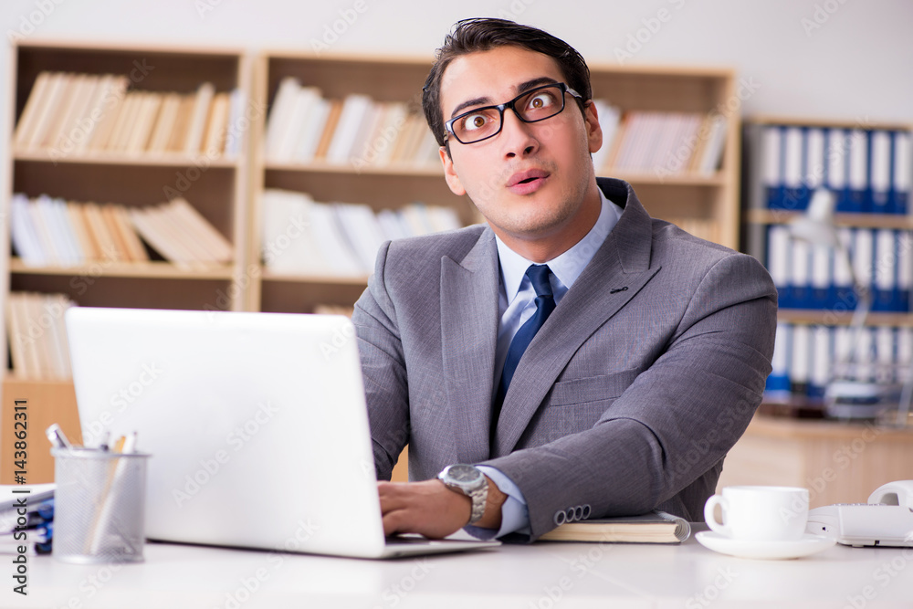 Angry businessman working in the office Angry businessman working in the office