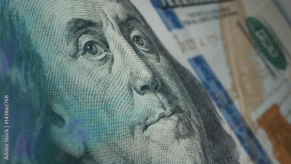 Sir Benjamin Franklin winks at a hundred-dollar bill.