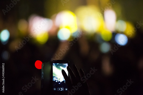 Crowd at concert and blurred stage lights .