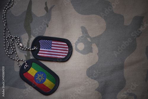 Bild auf Leinwand army blank, dog tag with flag of united states of america and ethiopia on the khaki texture background