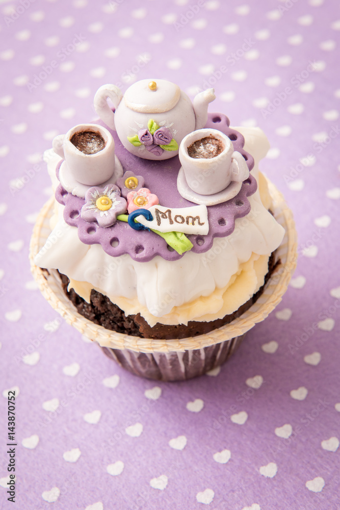 Cupcake with sugar kettle and cups. The concept of mother's day Cupcake with sugar kettle and cups. The concept of mother's day