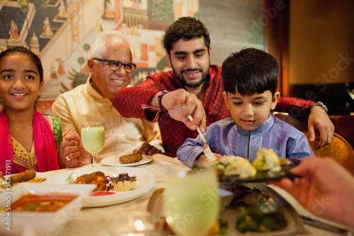 Multi generation family having dinner at restaurant