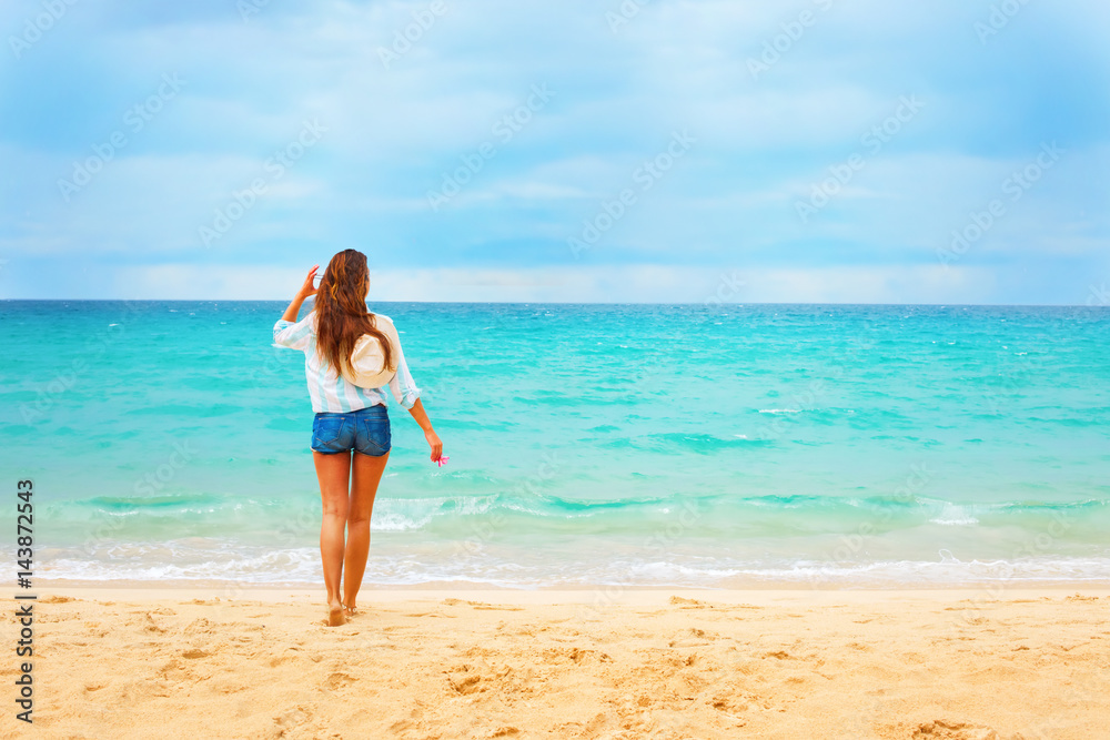 Beautiful Young Woman Looks on Blue Sea Summer