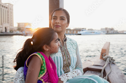Mother and daughter traveling on boat at Dubai Creek