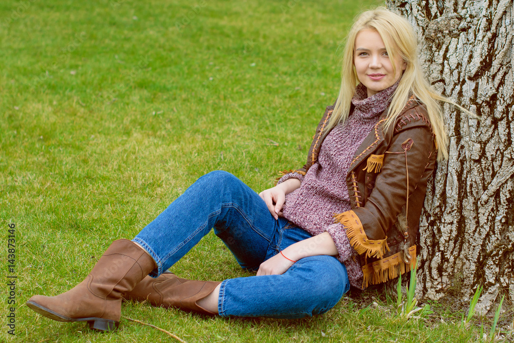 Young sexy stylish blonde girl in nature near a river and trees in American country style in a leather jacket, sweater blue jeans and brown boots with a beautiful face and pretty eyes
Young sexy stylish blonde girl in nature near a river and trees in American country style in a leather jacket, sweater blue jeans and brown boots with a beautiful face and pretty eyes