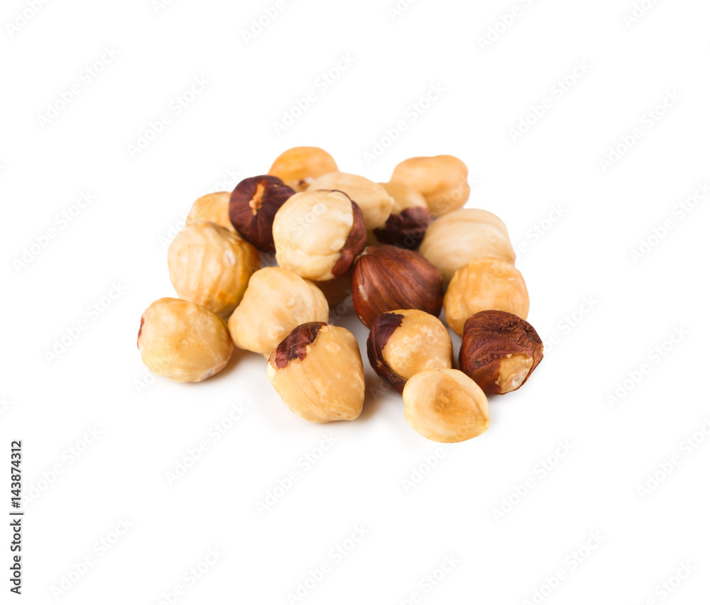 Pile of roasted hazelnuts close-up isolated on white background Pile of roasted hazelnuts close-up isolated on white background