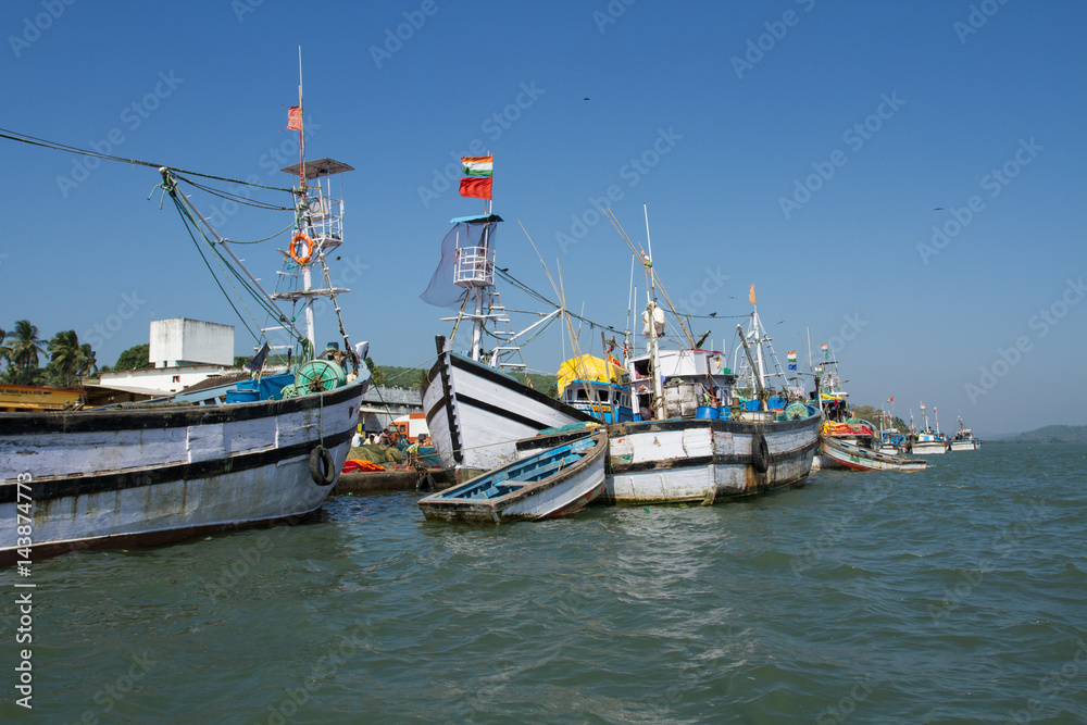 Noon in the fishing port. Parking of fishing boats in India
