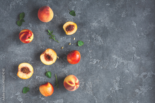 Fresh peaches on dark background. Flat lay, top view, copy space