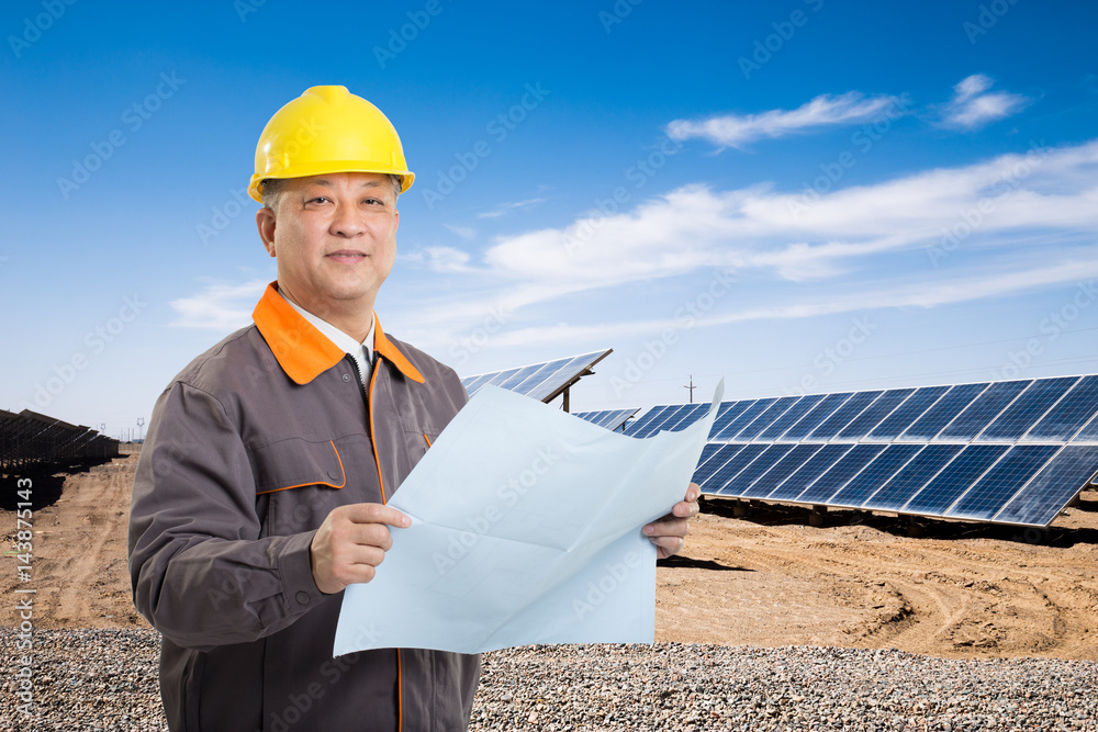 man technician with solar panels in country man technician with solar panels in country