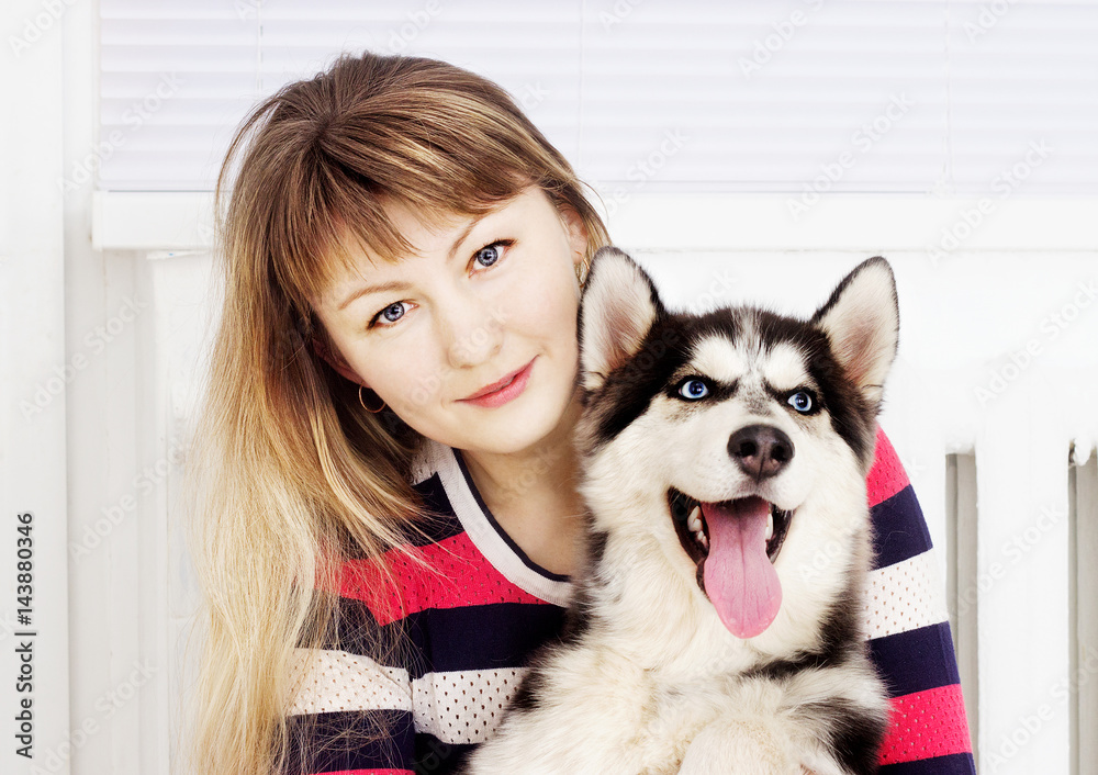 Woman and dog husky, hugging