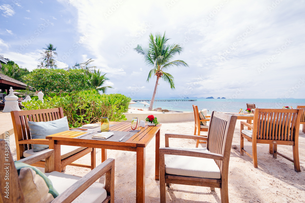 Table setting. Resort cafe on the tropical sea beach with beautiful view.