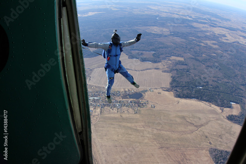 Skydiver has just jumped out of a plane.