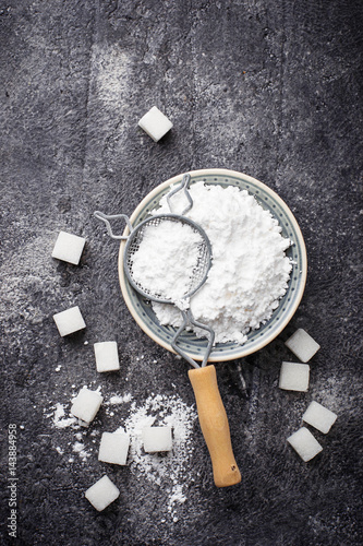 Sugar and powder on concrete background