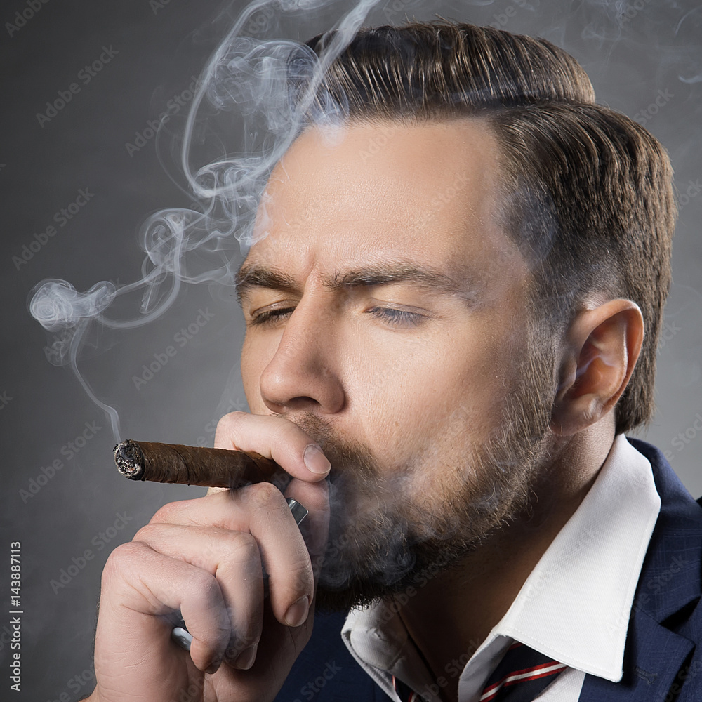 Closeup face of man smoking cigar. Hair style, beard, perfect skin Stock  Photo | Adobe Stock