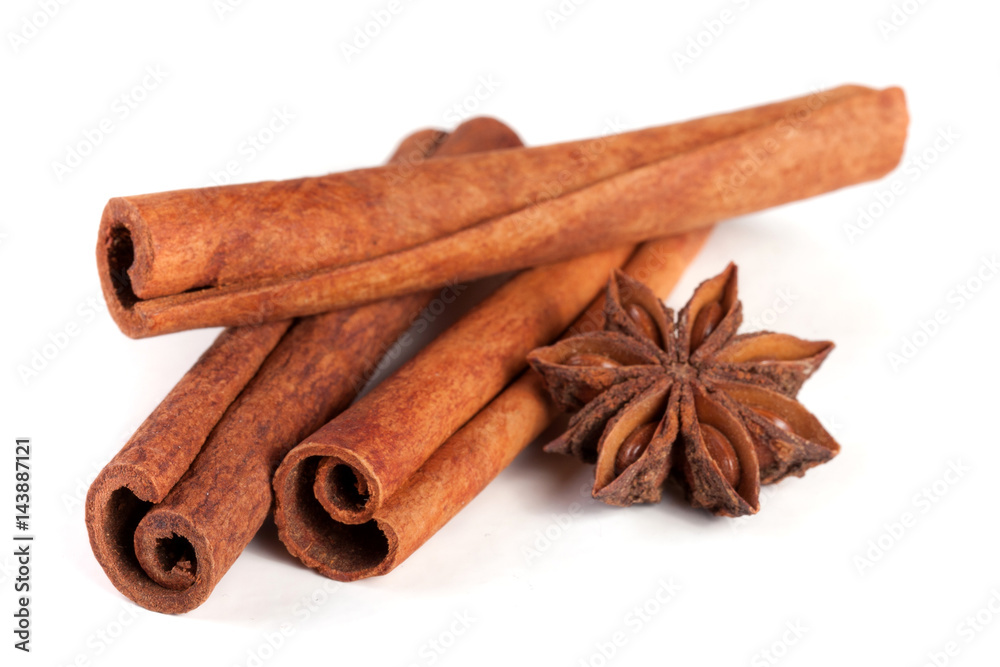 three cinnamon sticks with star anise isolated on white background three cinnamon sticks with star anise isolated on white background