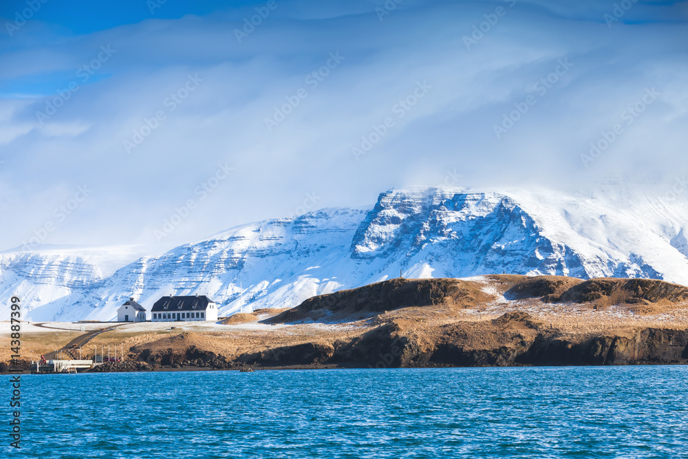 Coastal Icelandic landscape with snowy mountains