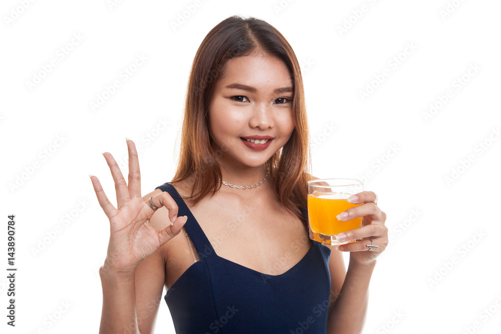 Young Asian woman drink orange juice show OK sign. Young Asian woman drink orange juice show OK sign.
