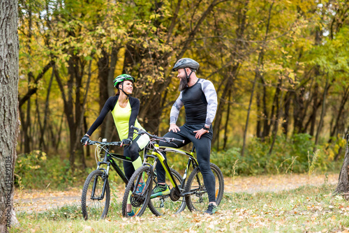 Cyclists with bikes in autumn park