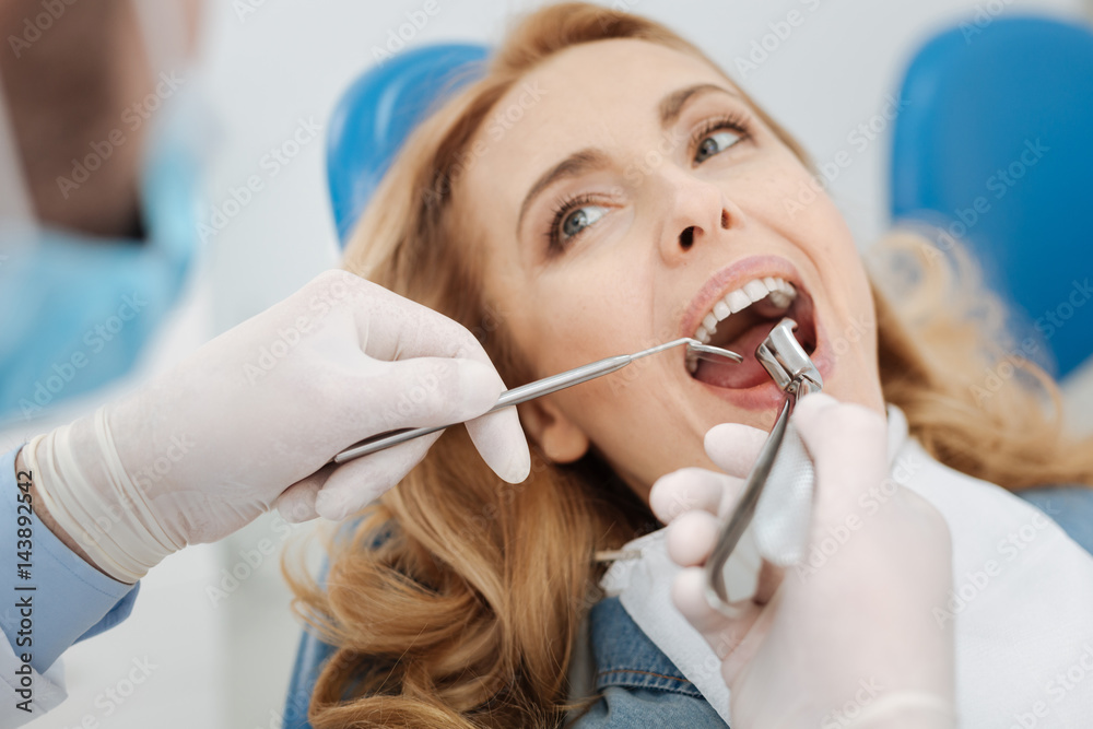 Competent skillful dentist doing some manipulations Competent skillful dentist doing some manipulations