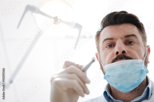 Successful committed dentist at work