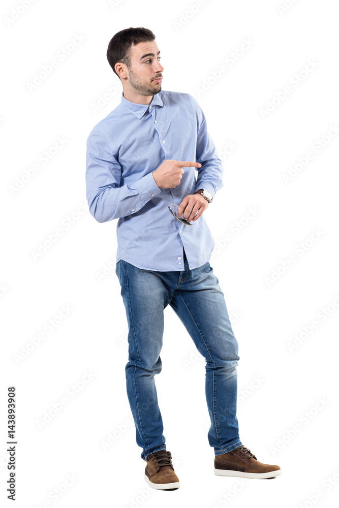 Blaming or accuse concept. Young businessman pointing finger looking away. Full body length portrait isolated over white background. Blaming or accuse concept. Young businessman pointing finger looking away. Full body length portrait isolated over white background.