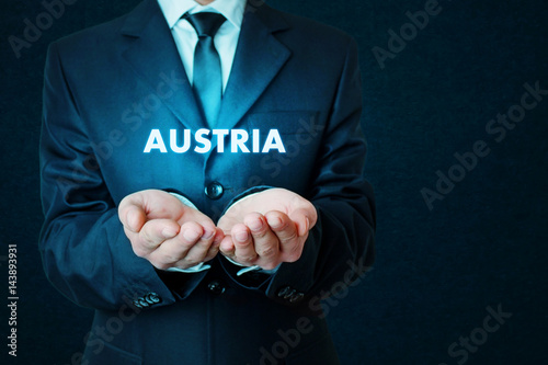 Businessman holding Austria word.