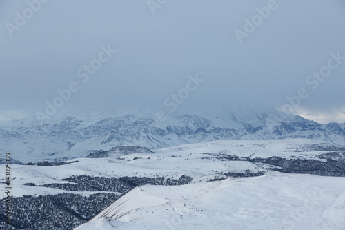 Russia. The formation and movement of clouds above the volcano Elbrus in the Caucasus Mountains in winter.