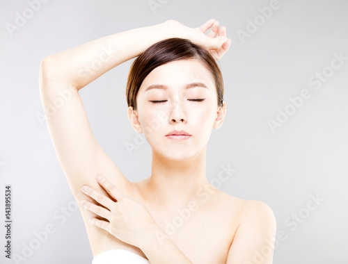 Young beautiful woman with perfect skin and armpit's care.