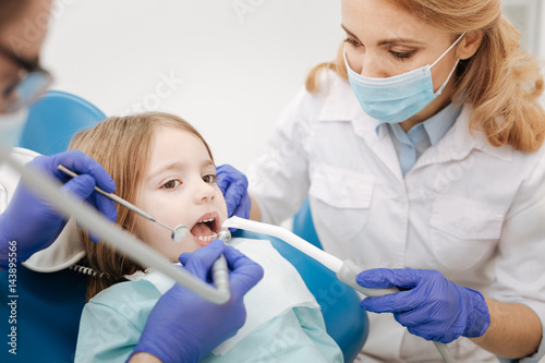 Caring gentle nurse assisting a dentists