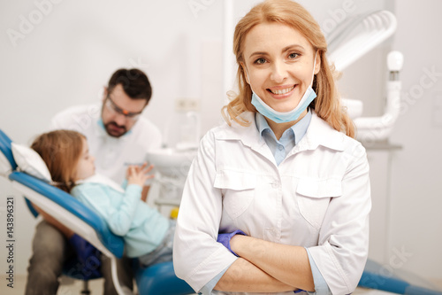 Pretty successful pediatric dentist posing in her office