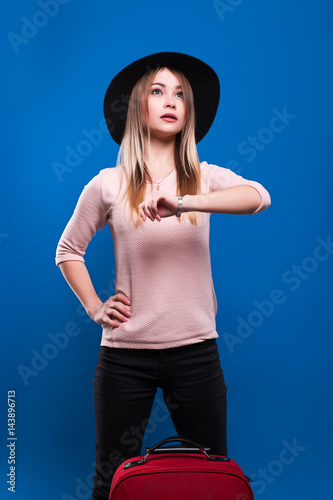 Beautiful young girl on a blue background with coffee and passport © aemstock