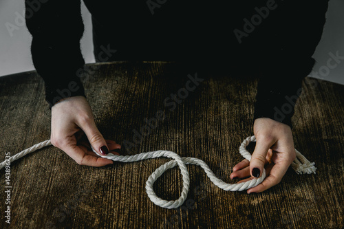 Hands holding piece of rope