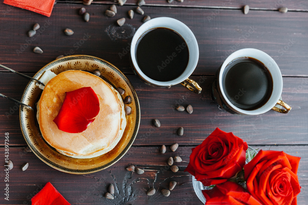 Breakfast coffee and pancakes on the table with roses Breakfast coffee and pancakes on the table with roses