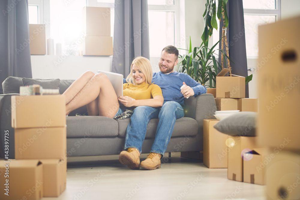 Couple moving into new apartment. Lot of packing cartons around them. Couple moving into new apartment. Lot of packing cartons around them.