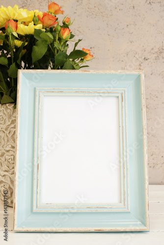 White Frame Mock Up. Rustic vase with roses. White background, empty place. Vintage tinted