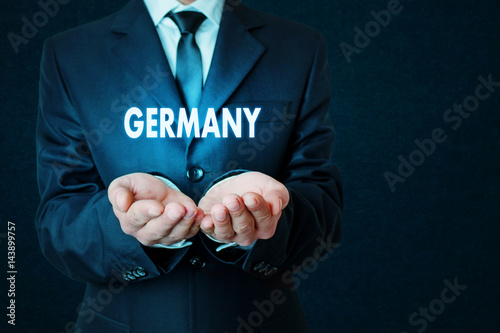 Businessman holding word of Germany