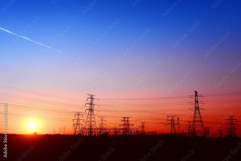 High voltage towers, under the setting sun