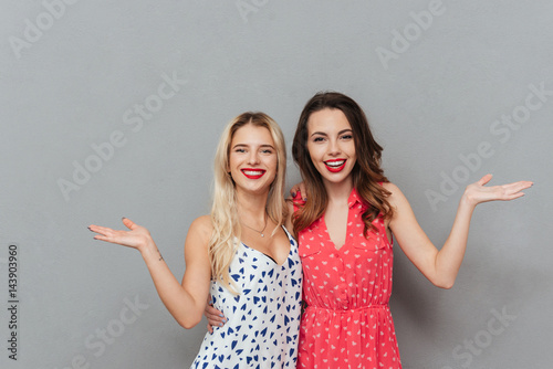 Happy young women holding copyspace.