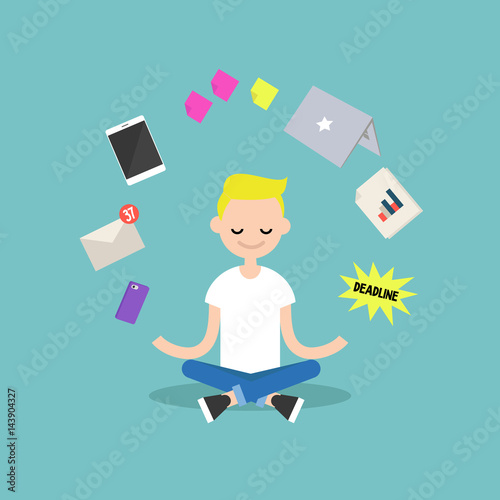 Young blond boy meditating with closed eyes in lotus pose surrounded by floating gadgets