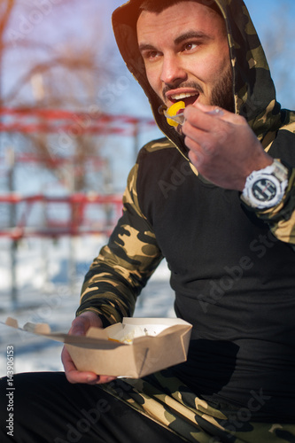 Male adult eating healthy food after workout