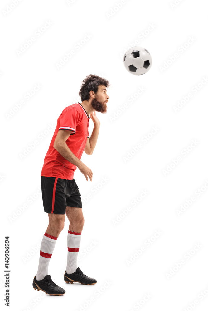 Guy in a red jersey heading a football Guy in a red jersey heading a football