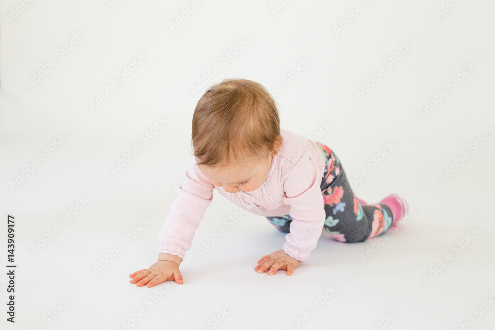 Cute baby girl on floor isolated over white background Cute baby girl on floor isolated over white background