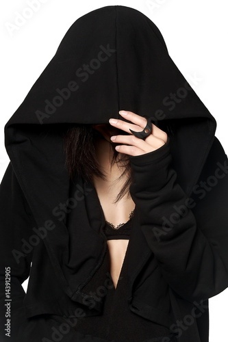 A girl in a black gown under a hood. Street fashion, gothic, hip-hop