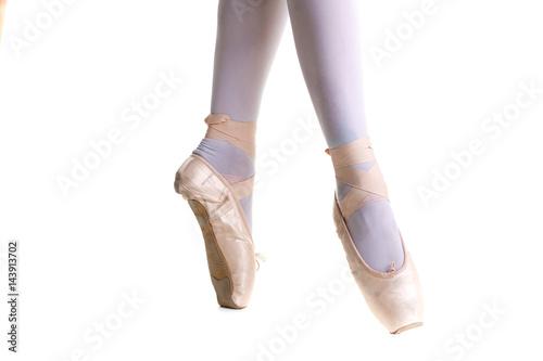 Closeup legs of young ballerina in pointe shoes