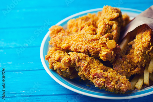 Crispy fried chicken breast on an old rustic wooden background, Close up. With a lot of copy space.